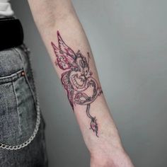 a woman's arm with a dragon tattoo on the left side of her arm