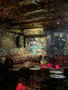 a living room filled with furniture and lots of graffiti on the walls