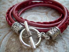 A Metallic Red Leather Bracelet.... Super stylish and feminine, wrap this twice around your wrist, toggle up and off you go. This Double Wrap Leather Bracelet features 3mm round, 3mm braided and 5mm flat braided metallic leather cords. Lead and Nickel Free - Aged Silver Toned Alloy Components, Secure Toggle Closure for Easy on and off. All dyes used in our leather are certified 100% Lead-Free and meet all requirements of the German Goods Ordinance, REACH (European Union), RoSH (U.K.), and CPSIA Handmade Red Wrap Bracelet, Trendy Red Adjustable Leather Bracelet, Adjustable Burgundy Bracelets, Red Leather Bracelet, Leather Bracelets Women, Bracelet Leather, Toggle Bracelet, Leather Bracelets, Unique Jewelry Designs