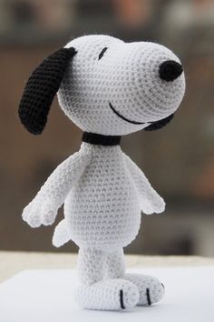 a crocheted stuffed dog with a black collar on it's head and legs