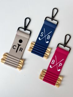 three different colored tags with wooden handles