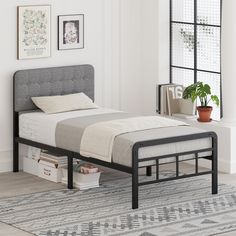 a bed sitting in a bedroom on top of a wooden floor next to a window