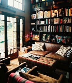 a living room filled with furniture and lots of books