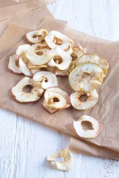 sliced apples are sitting on a brown paper bag