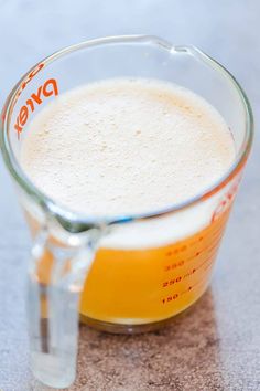 a measuring cup filled with liquid on top of a table