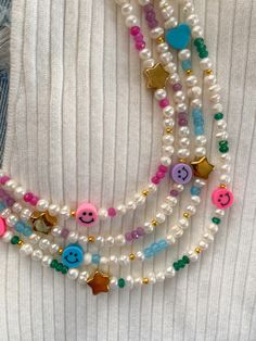 A beautiful natural pearl necklace with jade stones and happy face, heart and star beads, handmade 🤚 🤩✨ with a measurement of 14 inches and a beautiful 2-inch extender. ✨Fun necklace, for all ages, perfect for summer This and jade necklace is handmade ✋🏽 and I am always selecting pearls 👀 the best pieces for my creations, also the material is 100% stainless steel. We think a lot about each of our creations so that it is not a simple piece but a detail with a lot of meaning. ✨ What does your Smiley Face Necklace, Colorful Choker, Necklace Y2k, Natural Pearl Necklace, Y2k Necklace, Pearl Beaded Necklace, Handmade Jewlery, Face Necklace, Colorful Necklace