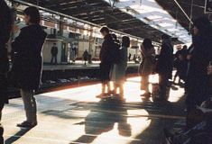 people waiting for the train to arrive at the station