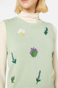 Herb flower embroidered vest- featuring hand embroidered herbs scattered across the body- round neckline- sleeveless style- ribbed neckline, hem adn armholes- plain jersey knit style- crafted from an acrylic cotton blend yarn- available in green Product Code: PGFX435