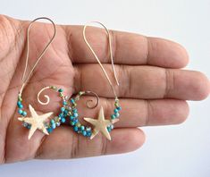 Made to order. Please refer to the shop announcement or the policies page for current production times. Genuine starfish are secured to golden tendrils, which are dotted with a mixture of blue and green stones including turquoise, apatite, peridot, and coral. The earring swirls have been formed by hand, and then hammered to create texture and strength. A perfect accessory for any beach lovin' babe. *Note: These earrings include tiny, real starfish that have been carefully coated in resin to make Unique Blue Hoop Earrings With Ear Wire, Handmade Turquoise Spiral Jewelry, Handmade Spiral Turquoise Jewelry, Unique Spiral Turquoise Jewelry, Unique Blue Spiral-shaped Jewelry, Ring Holder Necklace, Green Stones, Earrings Turquoise, Sleeping Beauty Turquoise