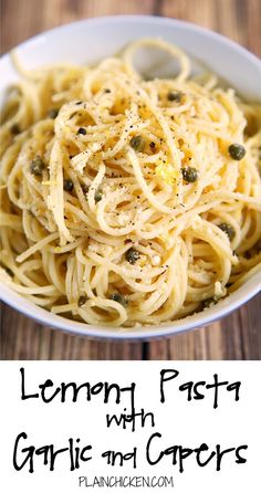 a white bowl filled with spaghetti and capers