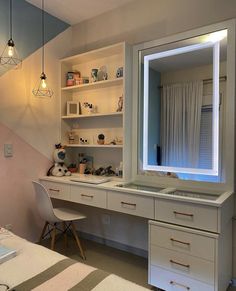 a room with a desk, mirror and lights on it's shelves in front of a window