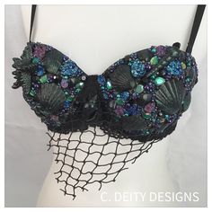 a black bra with blue and green sequins on the front, attached to a mesh net