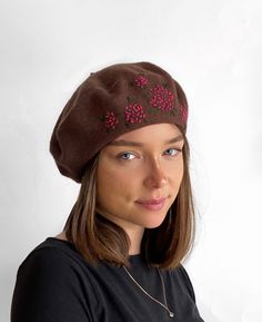 A  soft chestnut brown wool beret trimmed with delicate, coral hand embroidered hydrangea flowers for a feminine, unique look. The beret is an all-time classic that is the perfect flattering accessory for the cooler seasons. Easy to wear and reliable, you don't even need a mirror to style it on your head! Keep it folded flat in your bag and you will be always ready to make a statement! Other embroidered beret designs available from my shop  https://www.etsy.com/uk/shop/HatsByAgnieszka?ref=simple Brown Embroidered Hat, One Size, Brown One Size Beret For Winter, One Size Brown Beret For Winter, Handmade Brown Hats As Gifts, Handmade Brown Hat As A Gift, Handmade Brown Hat As Gift, Embroidered Hydrangea, Beige Beret, Embroidered Beret