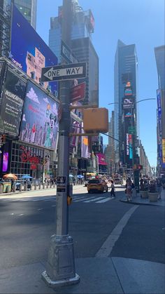 a city street filled with lots of tall buildings and billboards on the side of it