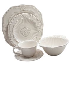 a white dinnerware set on a white background