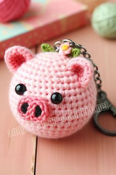 a small crocheted pig keychain on a table