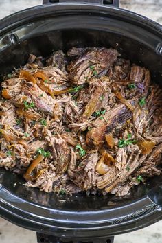 the meat is being cooked in the slow cooker