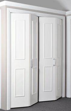 two white doors are open in an empty room with carpeted flooring and walls