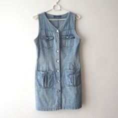 "Vintage Denim Shirt Dress Button Down Denim Dress Sleeveless Shirt Dress Navy Grunge Denim Dress Small Size Comfortable Denim Dress Estimated size: S Measurements (lying flat): Shoulders: 13\"/ 33 cm Pit to pit: 17.5\"/ 44.5 cm Width: 16\"/ 40.5 cm Hips: 18.5\"/ 47 cm Length total: 33\"/ 84 cm Condition: Very Good Vintage Condition Please check measurements to insure a proper fit. Remember to allow yourself some extra room for movement. You can compare these with something from your closet that fits you well. This dress will come to you freshly laundered and ready to wear. Please convo me if you need additional measurements. SHIPPING * I ship worldwide via Priority mail (Latvijas Pasts) from Latvia (EU). * I ship from Europe, so please allow 2 to 4 weeks for the package to arrive if you l Washed Blue Button-up Denim Vest For Summer, Sleeveless Denim Blue Vest With Buttons, Sleeveless Denim Vest With Buttons, Summer Denim Vest With Snap Buttons, Summer Denim Blue Vest With Snap Buttons, Sleeveless Light Wash Denim Top With Button Closure, Light Wash Sleeveless Denim Top With Button Closure, Fitted Sleeveless Buttoned Denim Jumpsuit, Fitted Sleeveless Denim Jumpsuit With Buttons