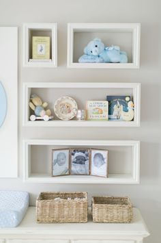 the shelves are filled with baby's toys and books, including pictures on them