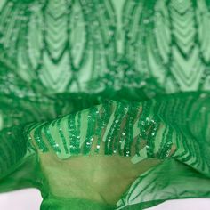 the green fabric has sequins on it