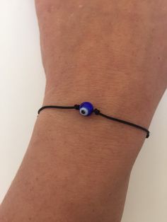 "BUY TWO GET A THIRD FOR FREE!! (please, don't add your free product to your shopping cart or you will be charged for it. Pick 1 product and leave the full name of it in the \"Note to enjoywelrydesign\" Box during checkout.)This is a black nylon cord bracelet with a crystal evil eye. Wear this bracelet to protect yourself. The evil eye is a curse believed to be cast by a malevolent glare, usually given to a person when they are unaware. Talismans created to protect against the evil eye. The brac Trendy Adjustable Evil Eye Friendship Bracelets, Trendy Adjustable Evil Eye Bracelet, Casual Evil Eye Friendship Bracelets As Gift, Casual Evil Eye Friendship Bracelets For Gifts, Adjustable Evil Eye Jewelry For Everyday, Casual Adjustable Evil Eye Bracelet As Gift, Adjustable Evil Eye Bracelet With Sliding Knot, Adjustable Evil Eye Bracelet For Everyday, Adjustable Spiritual Evil Eye Bracelet With Sliding Knot