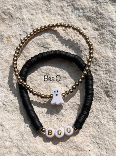 two bracelets with beads and charms that say bea o, ghost on the side