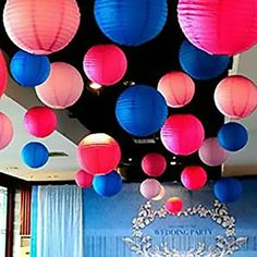 colorful paper lanterns are hanging from the ceiling