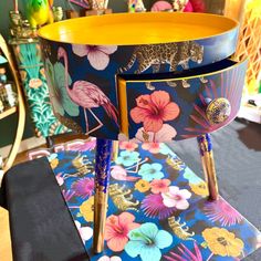 the table is decorated with colorful flowers and gold trimmings on it's sides