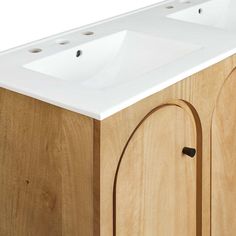 a bathroom vanity with two sinks and wood cabinetry on the side, against a white background