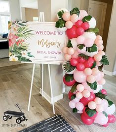 a welcome sign and balloon arch for a bridal shower