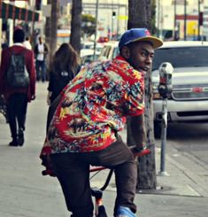 a man riding a bike down the street