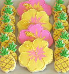 decorated cookies with flowers and pineapples on them