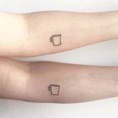 two arm tattoos with cups on them, one is black and the other is white