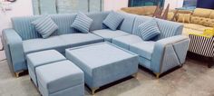 a blue couch and ottoman in a room