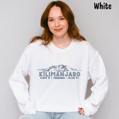 Mount Kilimanjaro Sweatshirt, Kilimanjaro Hiking Sweatshirt, Africa Nature Lover Shirt, Vintage Kilimanjaro Crewneck, Uhuru Peak, Tanzania The Wild Plume uses Gildan 18000 Crewneck Sweatshirts- ⭐️ 50% cotton, 50% polyester ⭐️ Relaxed fit, true to size, unisex   ⭐️ For an oversized look be sure to order in a larger size based on the size chart  ⭐️ Turn inside out when washing, machine wash cold, tumble dry low  ⭐️ Do not bleach and do not iron directly on design  ⭐️ Colors may differ from monitor White Long Sleeve Adventure T-shirt, White Long Sleeve T-shirt For Adventure, White Long Sleeve Sweatshirt For Adventure, White Long Sleeve Hiking Tops, White Long Sleeve Tops For Hiking, Hiking Sweatshirt, Africa Nature, Mount Kilimanjaro, Oversized Look