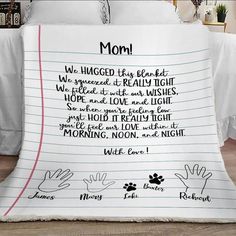 a blanket with writing on it that says mom, we hugged the bed and we spread it really high