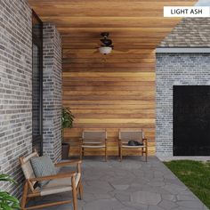 a porch with chairs and a fire place next to a brick wall that has wood slats on it