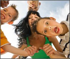 a group of children standing around each other