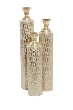 three gold vases sitting next to each other