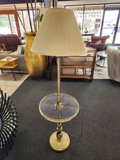 a lamp sitting on top of a table next to a chair in a living room