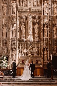 the bride and groom are standing at the alter