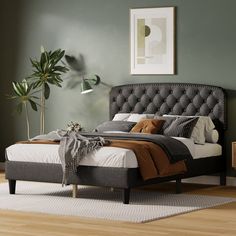 a bedroom with green walls and a bed in the middle is decorated with brown accents