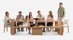 a group of people sitting around a wooden table