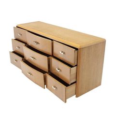 a wooden drawer with six drawers on top and two doors open to reveal the bottom