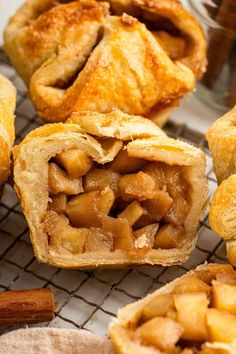 apple pies on a cooling rack with cinnamon sticks