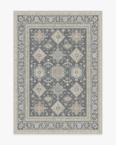 a blue and beige rug with an intricate design on the bottom, in front of a white background