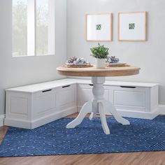 a corner table with two planters on it in the corner of a white room