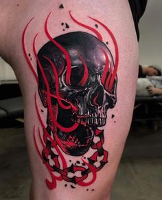 a skull with red flames on it's thigh