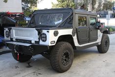 an off - road vehicle is parked on the street